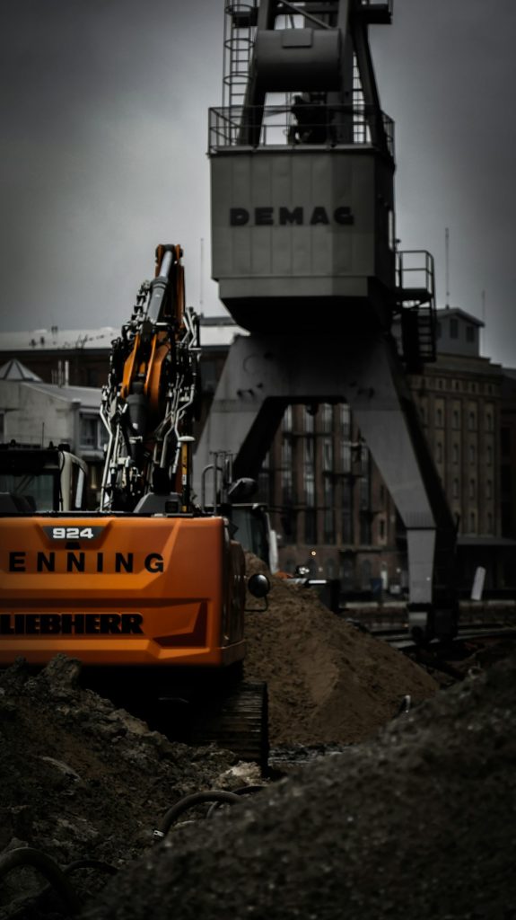 a-crane-is-sitting-on-top-of-a-pile-of-dirt-lxgop8zwe5s Construction site on harbor
