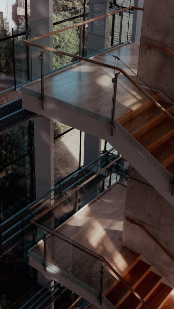 modern-architectural-indoor-staircase-design-35173077 Stylish indoor staircase with glass railings and wooden steps, ideal for contemporary architecture themes.