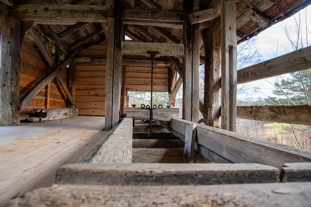 A detailed view of a rustic wooden sawmill structure in Norway, showcasing traditional craftsmanship.